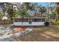 Cute bungalow with screened porch, fenced yard, and spacious driveway at 1376 18Th St, Sarasota, FL 34234