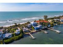 Aerial view of waterfront home with private dock, ocean access, and lush landscaping at 1620 Casey Key Rd, Nokomis, FL 34275