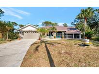 Single-story house with attached garage and a screened porch at 1819 Bridge St, Englewood, FL 34223