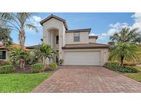 Two-story home with brick driveway and landscaped lawn at 19344 Cruise Dr, Venice, FL 34292