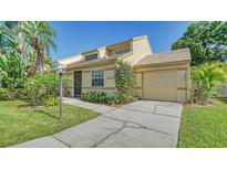 Tan two-story home with attached garage and lush landscaping at 3429 57Th Avenue W Dr # 15, Bradenton, FL 34210