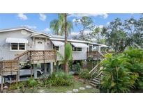 Elevated home with wrap-around deck, offering ample outdoor space at 39200 Cook Brown Rd, Punta Gorda, FL 33982