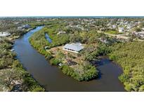 Waterfront property with private dock and mature trees surrounding the house at 4191 Strombus Rd, Venice, FL 34293