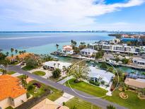 Aerial view of waterfront home with private dock and lush landscaping at 536 Ketch Ln, Longboat Key, FL 34228