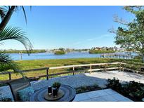 Stunning water view from patio, featuring a table and chairs at 6047 E Peppertree Way # 224, Sarasota, FL 34242