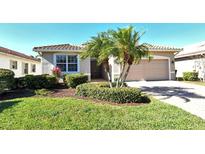 Single-story home with a two-car garage and landscaped front yard at 6422 42Nd E St, Sarasota, FL 34243