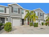 Townhome exterior shows well-maintained landscaping and attached garage at 6620 Serenity Fall Ln, Sarasota, FL 34240