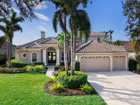 Beautiful two-story home with tile roof, landscaping, and three-car garage at 9420 Old Hyde Park Pl, Lakewood Ranch, FL 34202