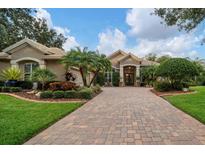 Beautiful home with a large driveway and lush landscaping at 11432 Savannah Lakes Dr, Parrish, FL 34219
