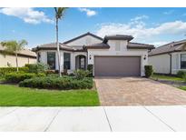 Attractive one-story home with a two-car garage and landscaped front yard at 12458 Marsh Pointe Rd, Sarasota, FL 34238