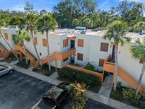 Exterior view of condo building with palm trees and parking at 151 Wild Palm Dr # 151, Bradenton, FL 34210