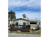 Mobile home with deck and tropical landscaping at 2601 Gulf N Dr # 510, Bradenton Beach, FL 34217