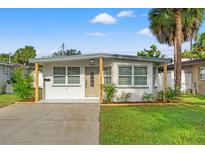 Charming single story home with a well-manicured lawn at 3066 Highland N St, St Petersburg, FL 33704