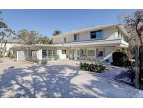 Two-story house with unique architectural details and a spacious driveway at 3712 Sandspur Ln, Nokomis, FL 34275