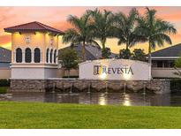 Gated community entrance with a water feature and attractive signage at sunset at 5447 Tripoli Dr, Palmetto, FL 34221