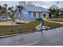 Cute blue cottage with unique landscaping, whimsical yard art, and a mermaid mailbox at 7061 Longboat E Dr, Longboat Key, FL 34228