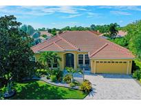 Aerial view of a beautiful home in a lush, well-maintained community at 7596 Palmer Glen Cir, Sarasota, FL 34240