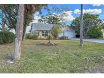 Landscaped front yard with mature trees and a spacious driveway at 1204 W 20Th Ave, Palmetto, FL 34221