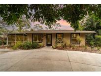 Cute updated bungalow, featuring a large driveway and lush landscaping at 2885 Arrowhead Rd, Venice, FL 34293