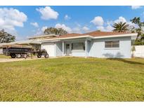 House with a green lawn, white garage, and light blue exterior at 3231 Yorktown St, Sarasota, FL 34231