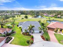 House with golf course and lake views in a community at 6170 Misty Oaks Dr, Sarasota, FL 34243