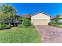 Single-story home with a paved driveway, landscaping, and a two-car garage at 6512 Willowshire Way, Bradenton, FL 34212