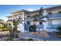 Two-story building with balconies, a staircase, and landscaping at 6800 Placida Rd # 2017, Englewood, FL 34224