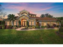 Elegant two-story home with manicured landscaping and a welcoming entryway at 6919 Winners Cir, Lakewood Ranch, FL 34202