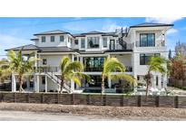 Stunning modern home with a metal roof, expansive windows, and a pool at 7007 Point Of Rocks Rd, Sarasota, FL 34242