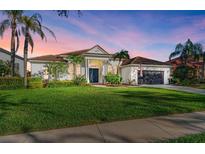 Stunning one-story home with a beautifully landscaped lawn and a three-car garage at 7555 Tori Way, Lakewood Ranch, FL 34202