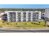 Building's exterior, showcasing landscaping and ocean views at 757 Beach Rd # 208, Sarasota, FL 34242