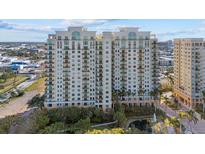 Aerial view of a luxury condo building with pool and water views at 800 N Tamiami Trl # 1502, Sarasota, FL 34236