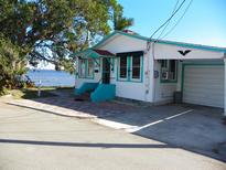 Waterfront cottage with teal accents and garage at 9 Plaza E St, Bradenton, FL 34208