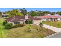 Single-story home with red tile roof and a large driveway at 121 Van Dyck Dr, Nokomis, FL 34275