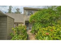 Front entrance of condo with lush landscaping at 1621 Clower Creek Dr # Tr173, Sarasota, FL 34231