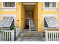 Inviting yellow building exterior with white accents and stairs at 3640 41St S Ln # F, St Petersburg, FL 33711