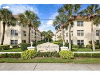 Beach Harbor Club's inviting exterior with lush landscaping, tropical palms, and well-maintained facade at 3810 Gulf Of Mexico Dr # F105, Longboat Key, FL 34228