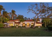 Back of house with lawn, palm trees, and pool at 3930 Red Rock Way, Sarasota, FL 34231