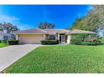 Single-story house with attached garage and well-maintained lawn at 601 Lakescene Dr, Venice, FL 34293