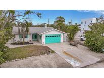 Charming single story home with teal garage door and well-manicured lawn at 633 Avenida De Mayo, Sarasota, FL 34242