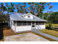 Charming bungalow with metal roof, screened porch, and spacious yard at 1717 32Nd St, Sarasota, FL 34234