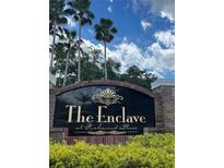 The Enclave at Richmond Place entrance sign, featuring a brick and granite design at 18001 Richmond Place Dr # 1222, Tampa, FL 33647