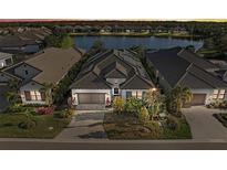 Luxury home with solar panels and lake view in a gated community at 328 Aria Dr, Nokomis, FL 34275