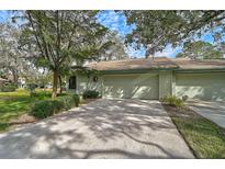 Home's exterior showcasing a two-car garage and driveway at 4655 Pine Green Trl # 24, Sarasota, FL 34241