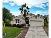 One-story home with a landscaped yard and a two-car garage at 5154 51St W Ln, Bradenton, FL 34210