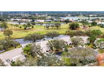 Scenic aerial view of property on the golf course, with lush landscaping and water features at 5432 Hampstead Heath # 26, Sarasota, FL 34235