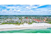 Aerial view of beachfront condo building with pool and ocean views at 6140 Midnight Pass Rd # 902, Sarasota, FL 34242