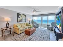 Living room boasts ocean views and comfortable seating at 6140 Midnight Pass Rd # 902, Sarasota, FL 34242