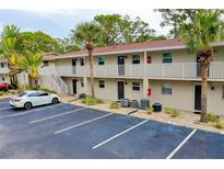 Two-story condo building with parking and tropical landscaping at 972 La Costa Cir # 5, Sarasota, FL 34237