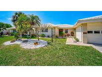 Attractive Florida home with palm trees and well-manicured lawn at 337 Dante Dr # 337, Nokomis, FL 34275